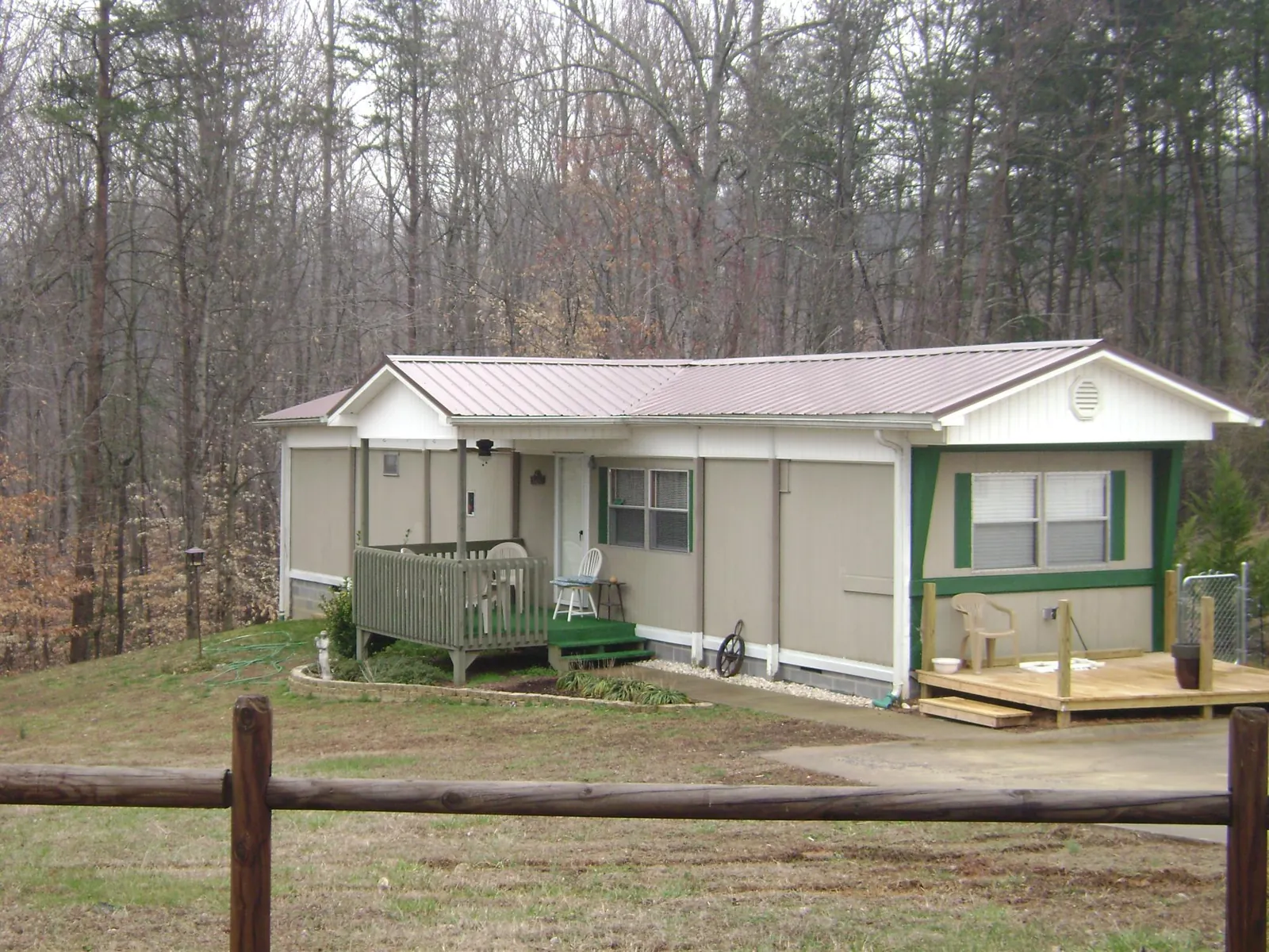 Mauve metal roof on a manufactured home with a new front deck in Canaan